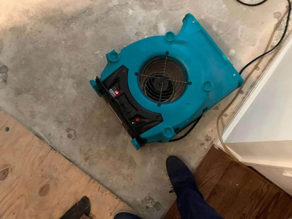 Air mover drying subfloor during Commercial Water Damage Restoration in Highlands